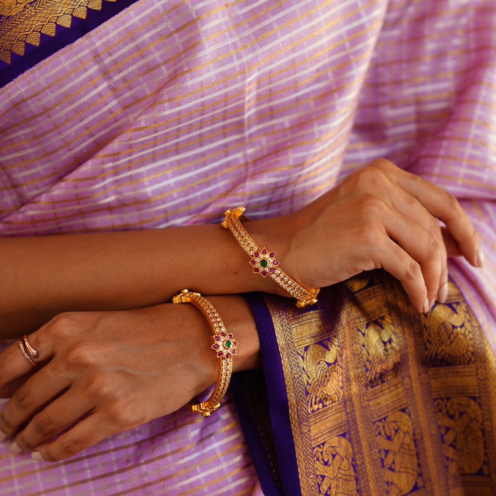 GOLD PLATED ZIRCON BANGLE WITH FLOWER MOTIF.