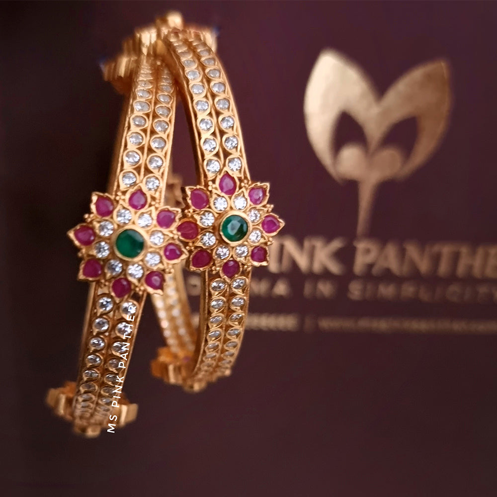 GOLD PLATED ZIRCON BANGLE WITH FLOWER MOTIF.